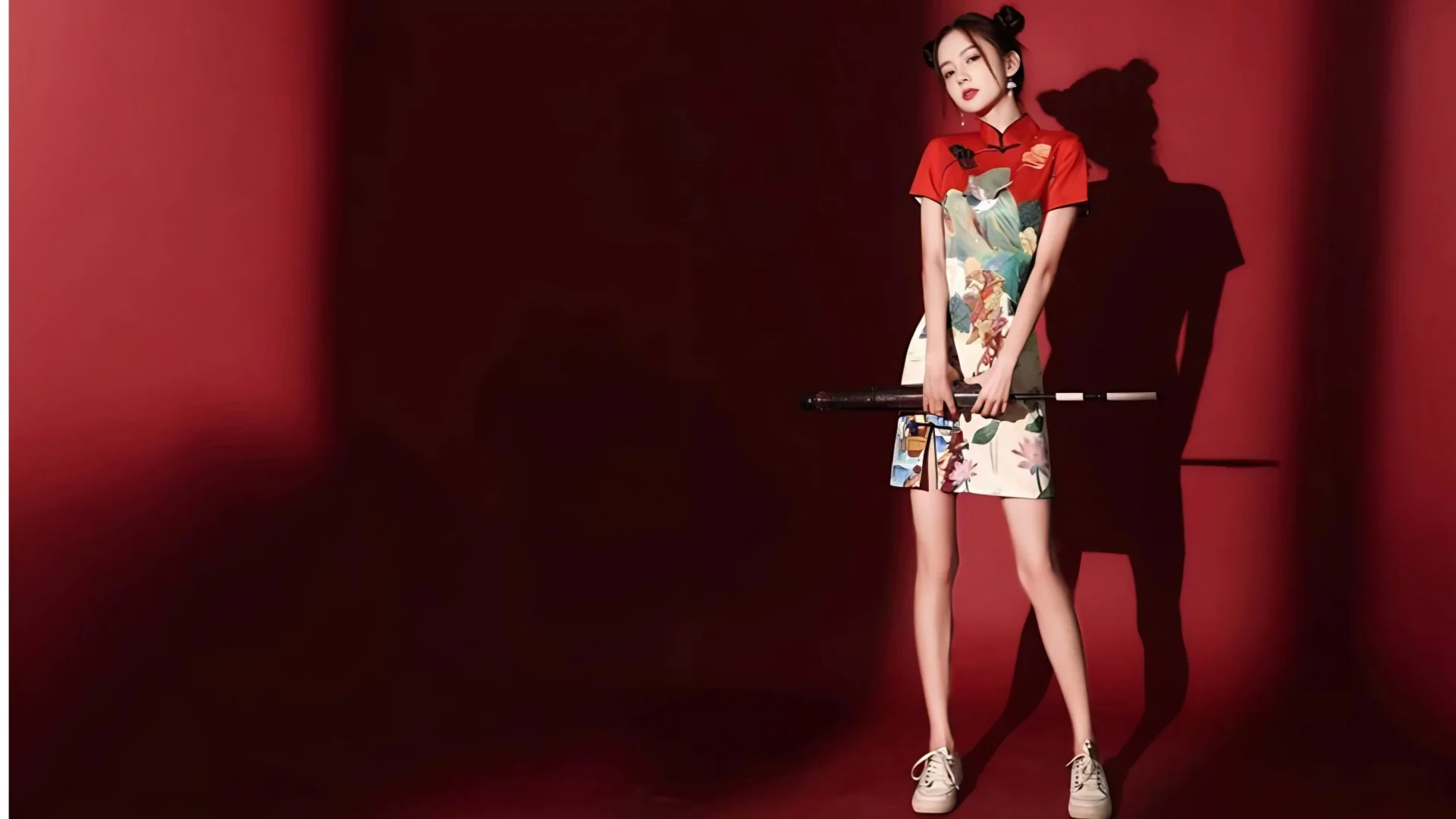 Woman in red modern cheongsam-style hanfu, paired with a sword, a fusion of traditional and trendy Chinese costume design